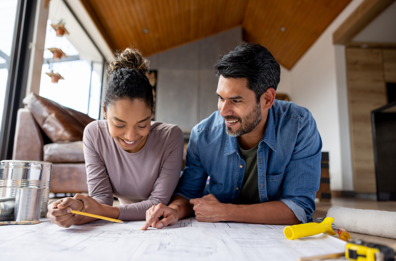 Couple looking at blueprints together.